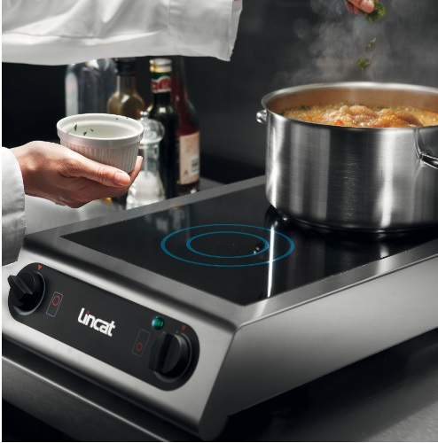 Lincat induktioliesi IH21. Kuvassa kokki lisää raaka-aineita valmistamaansa ruokaan.